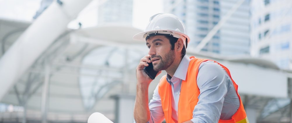 Man,engineer,standing,on,construction,site.,construction,manager,using,walkie